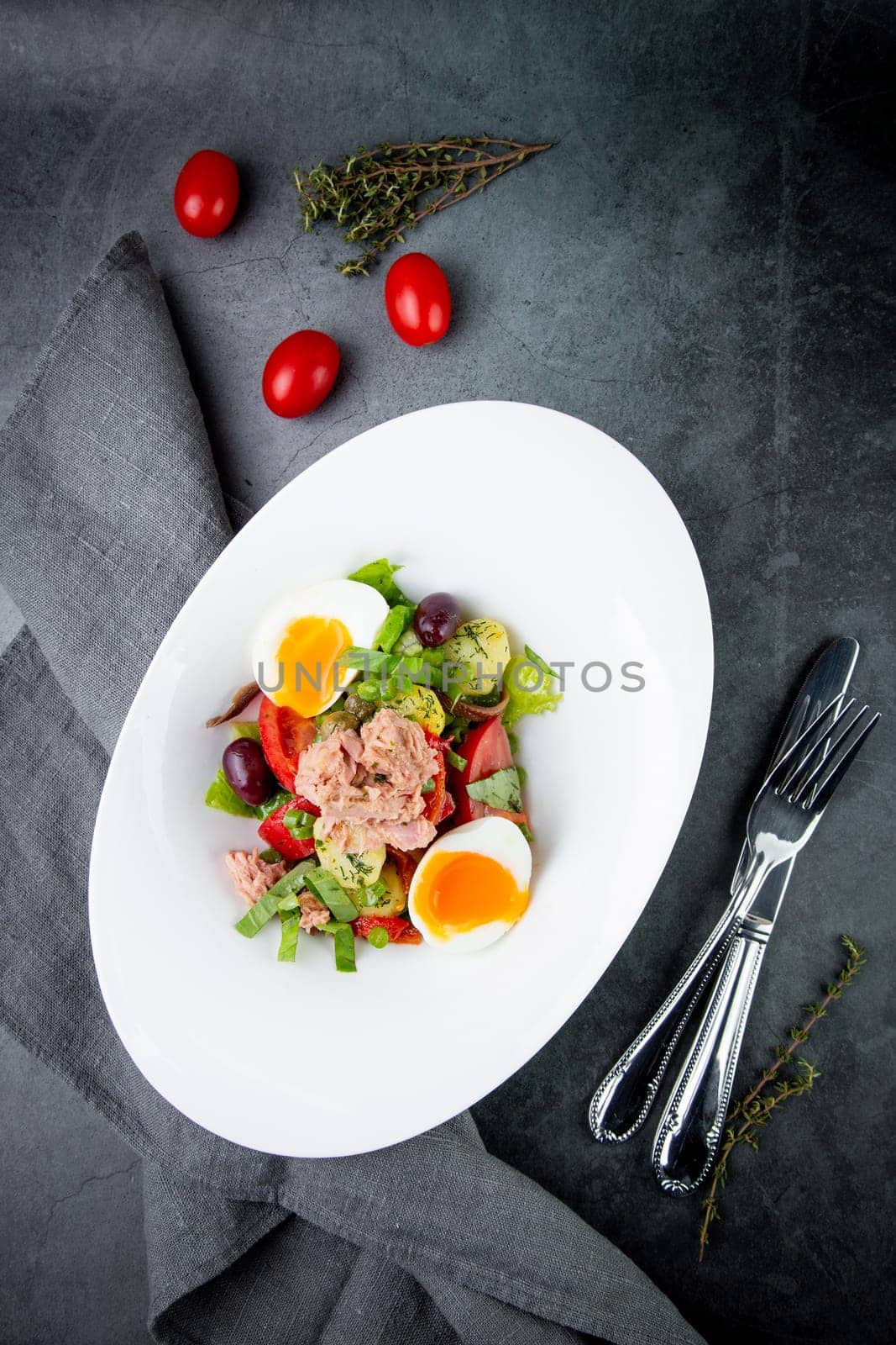 salad with soft-boiled egg, tuna, green onions, boiled potatoes, top view by tewolf