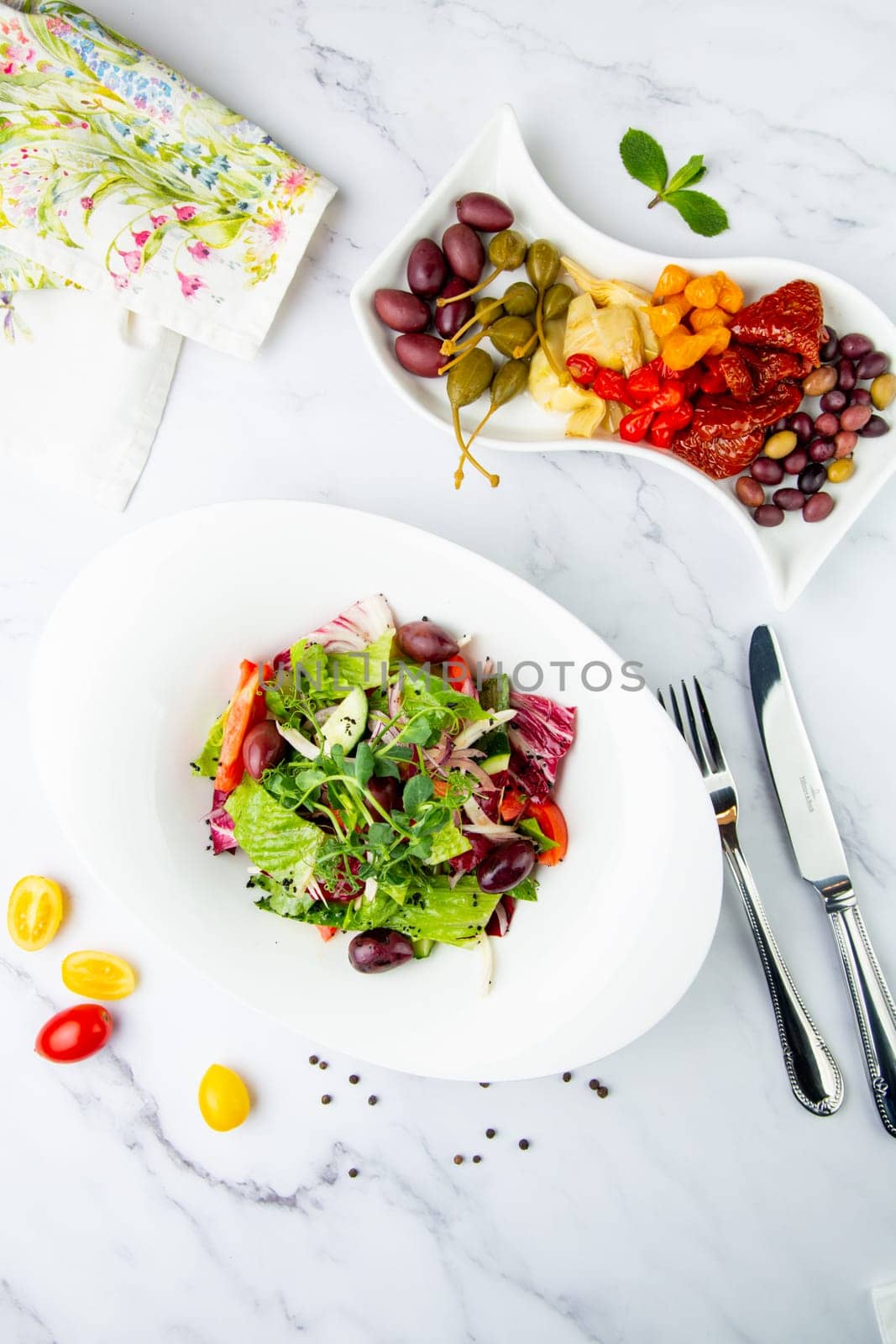 salad of greens, lettuce leaves, cucumbers, pink onions, top view by tewolf