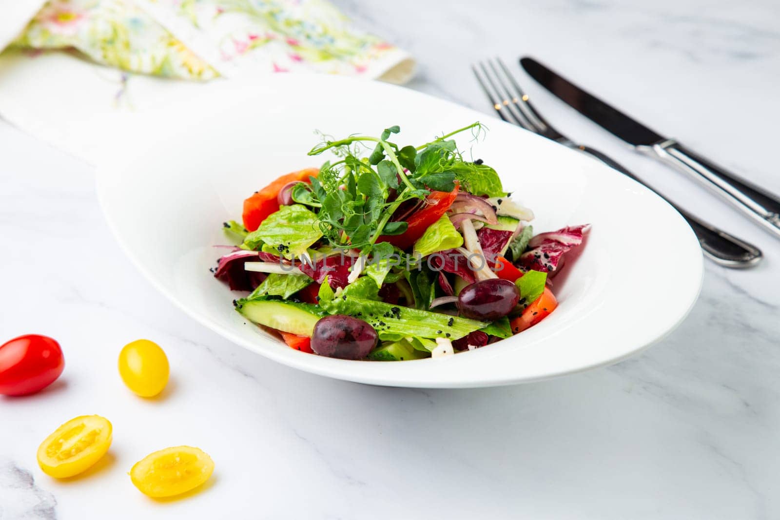 salad of greens, lettuce leaves, cucumbers, pink onions, side view by tewolf