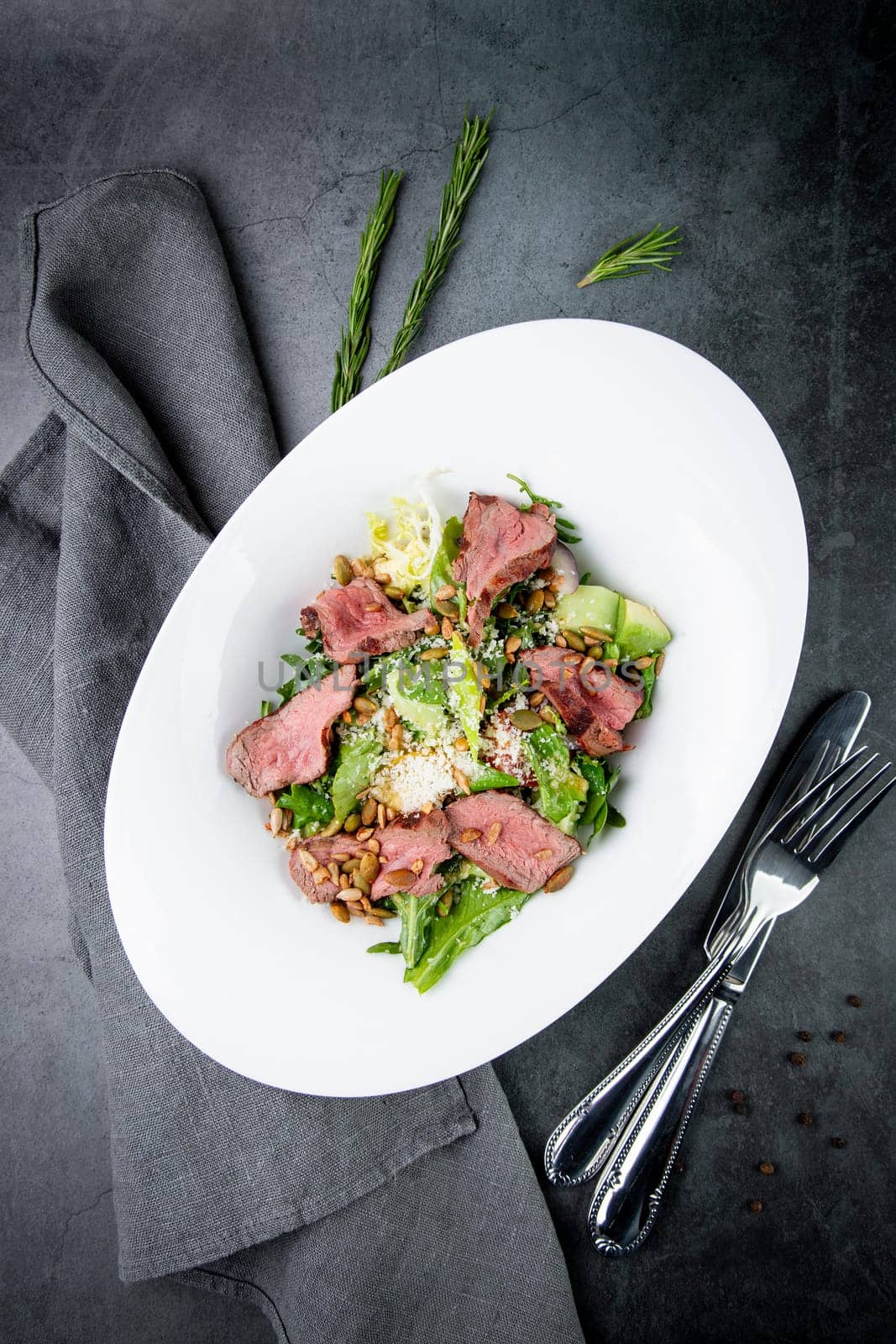 salad with pieces of beef, pistachios, lettuce and cheese. High quality photo