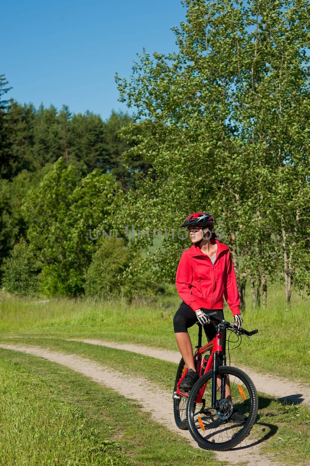 Summer - young woman ride mountain bike in nature