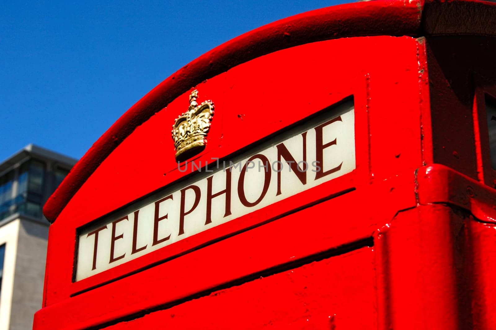 Traditional red telephone booth with the crown of St. George in central London