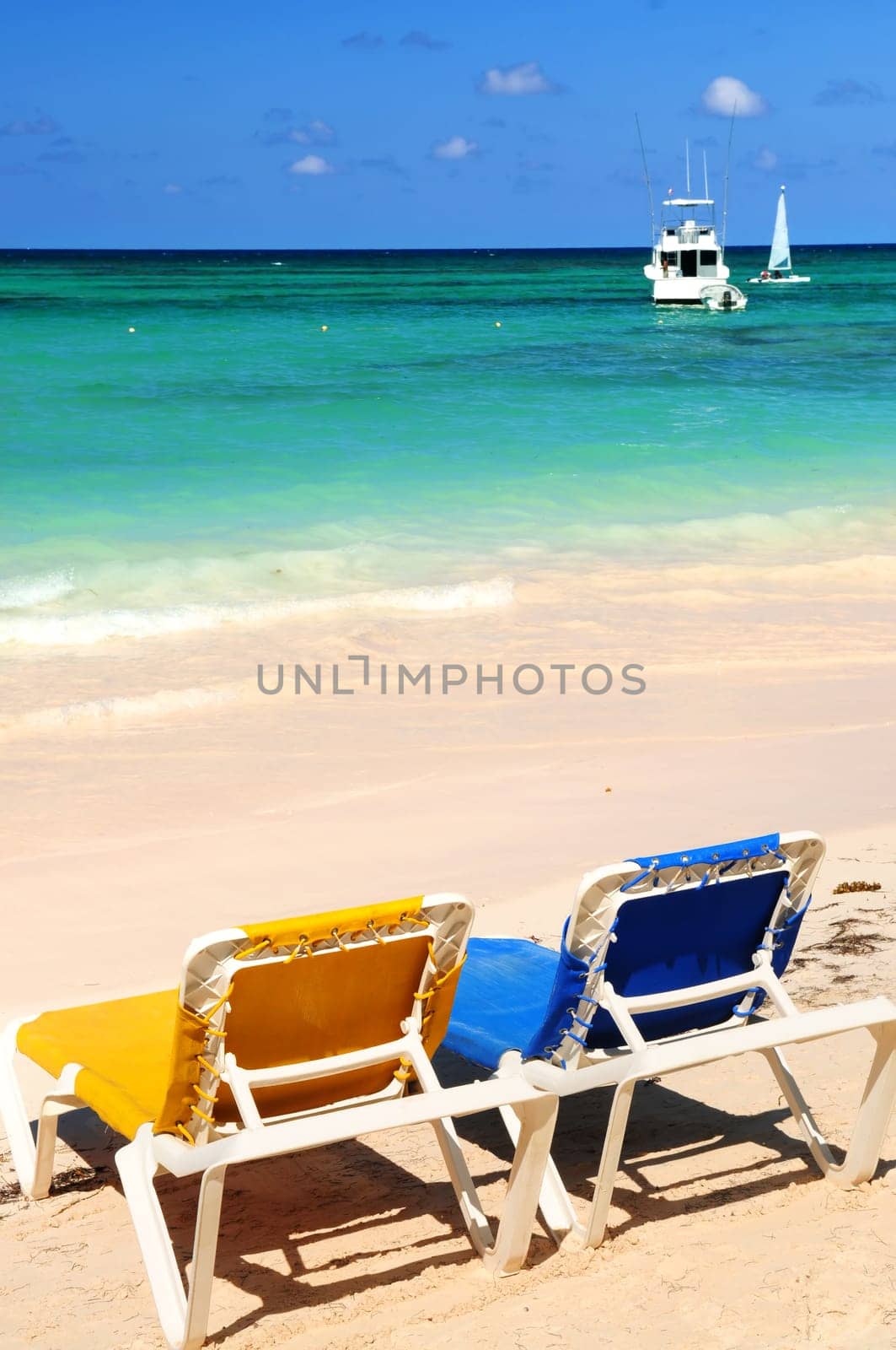 Chairs on sandy tropical beach