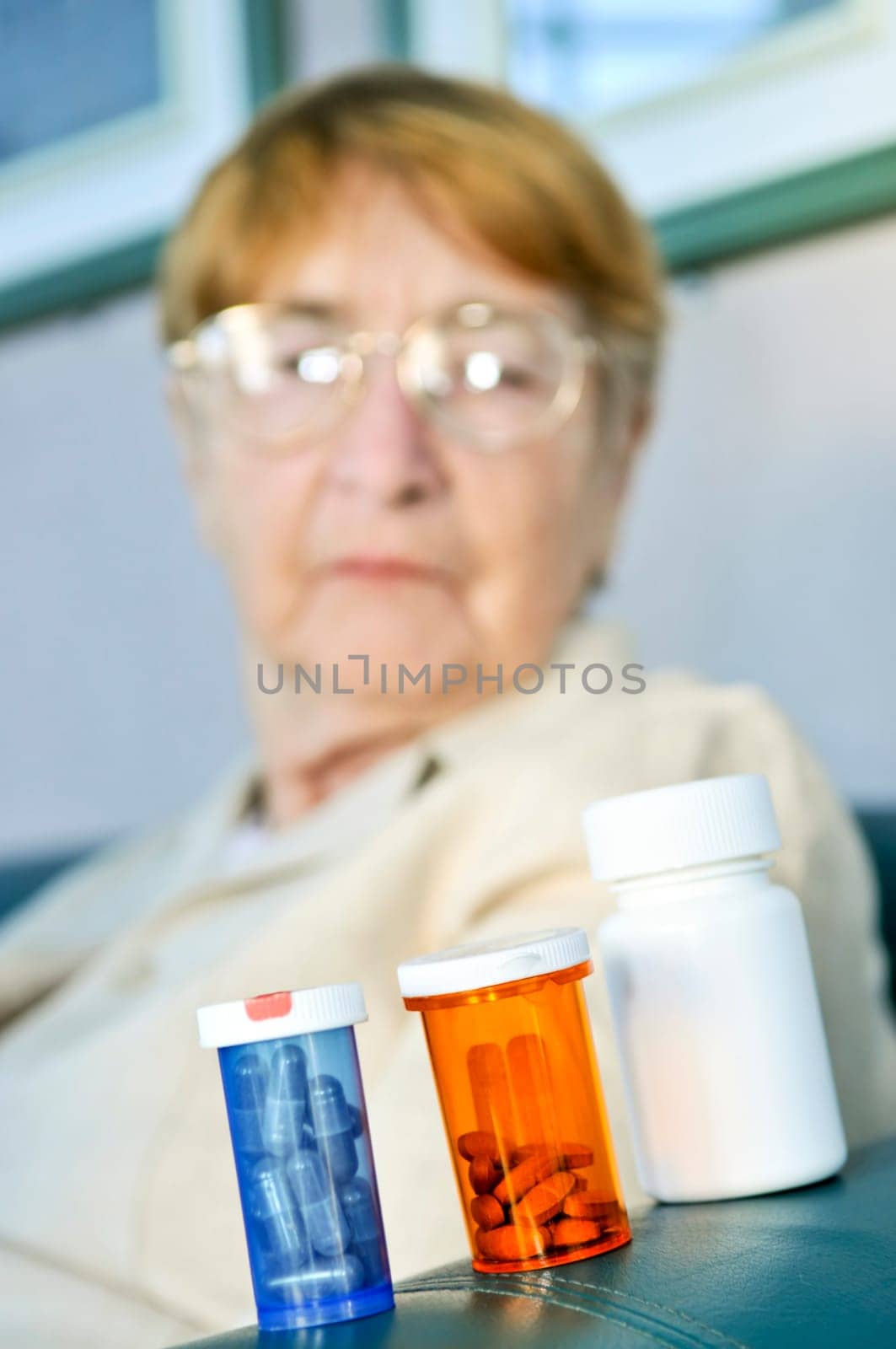 Elderly woman with pill bottles