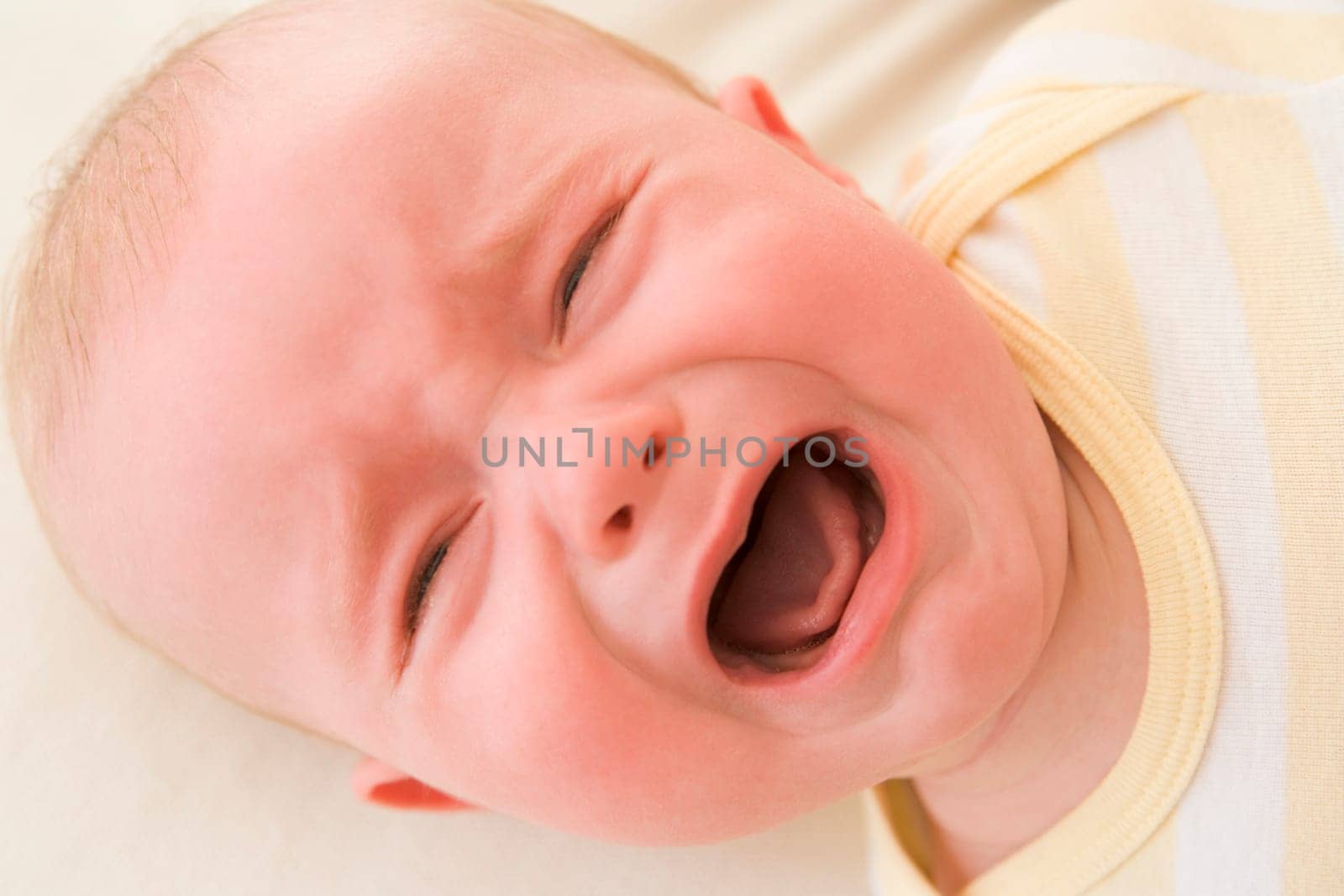 Baby lying indoors crying