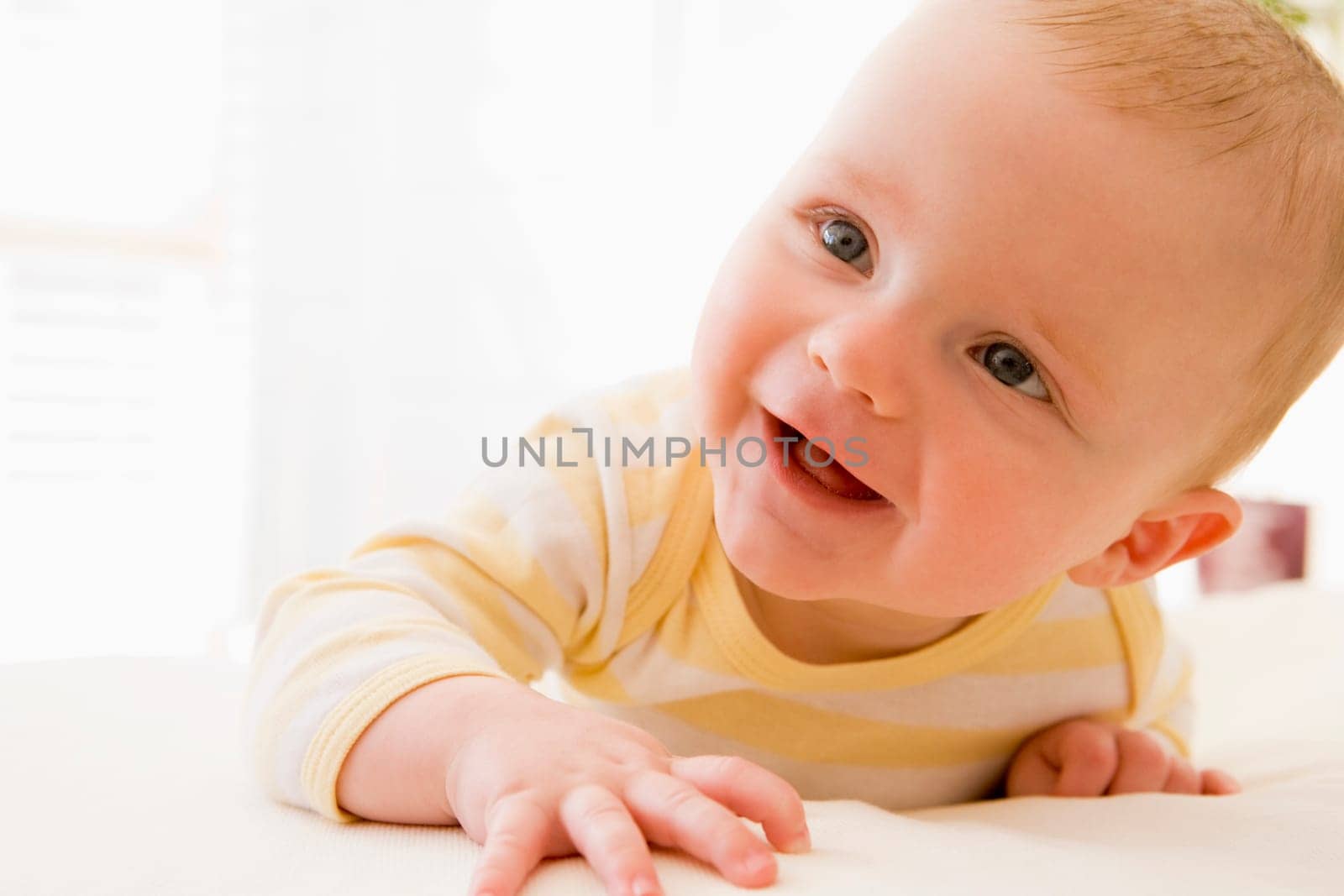 Baby lying on bed