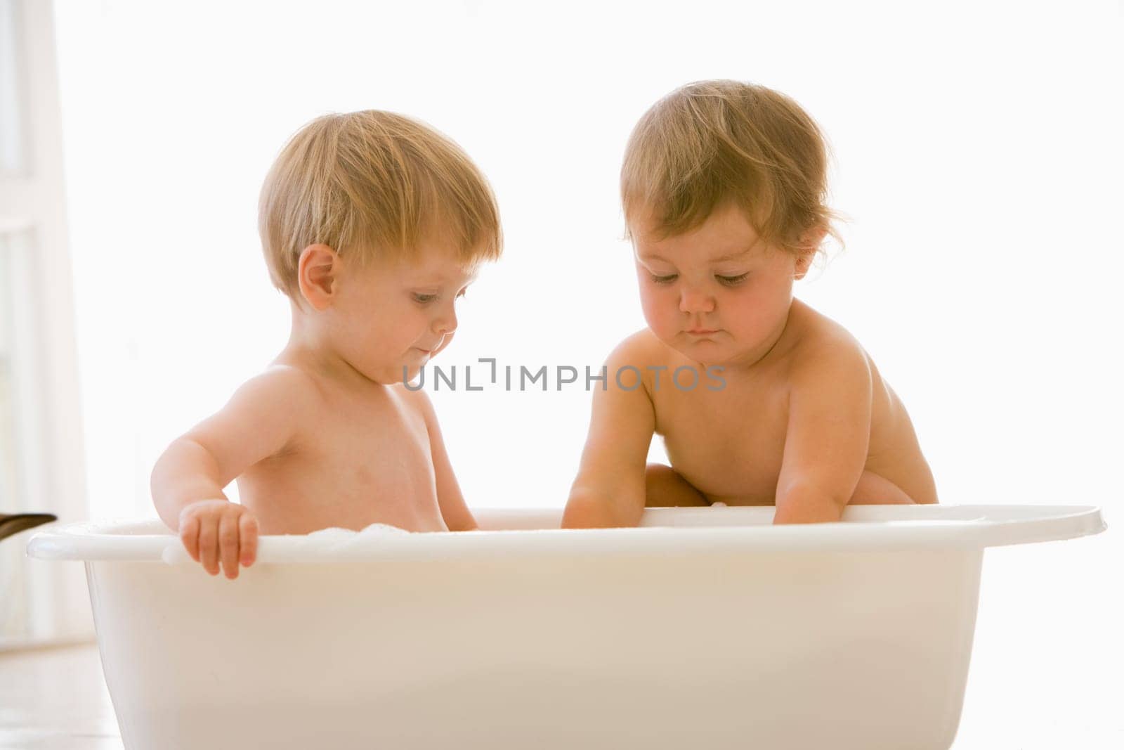 Two babies in bubble bath