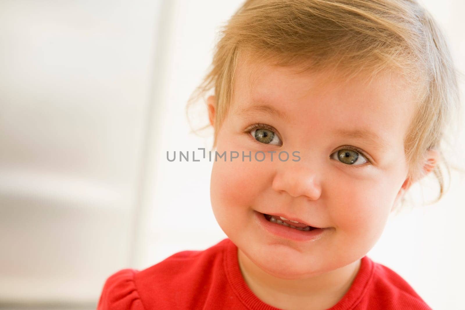 Baby indoors smiling