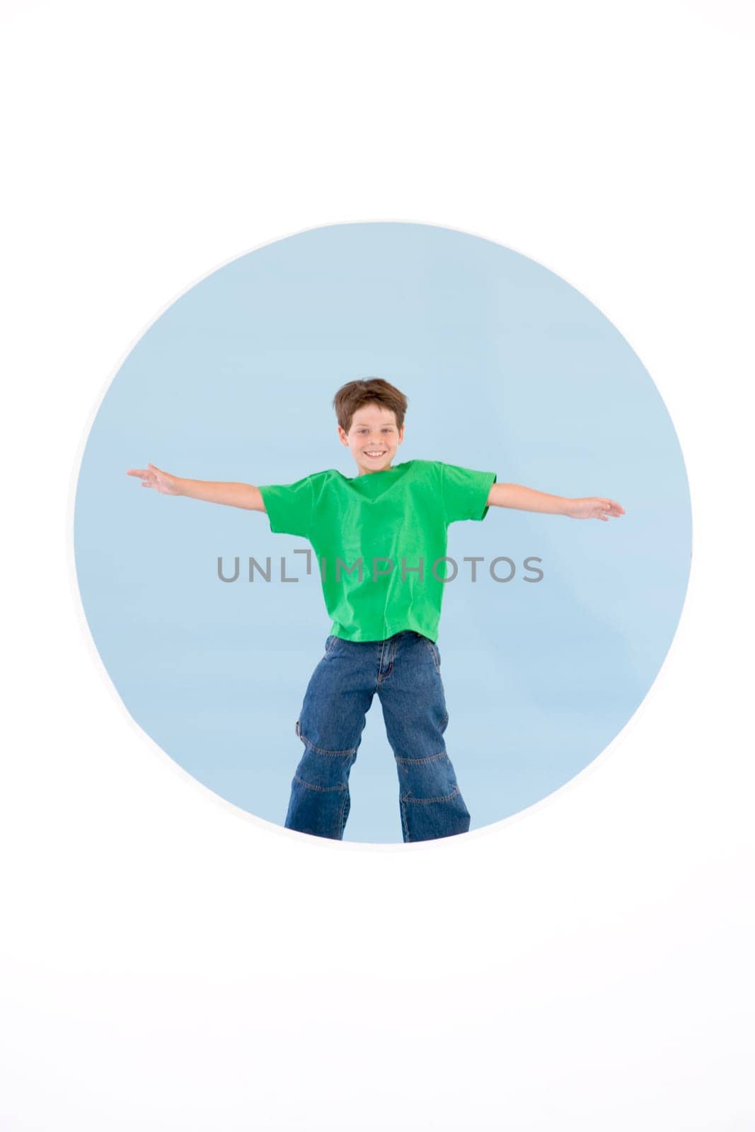 Young boy standing with arms out smiling