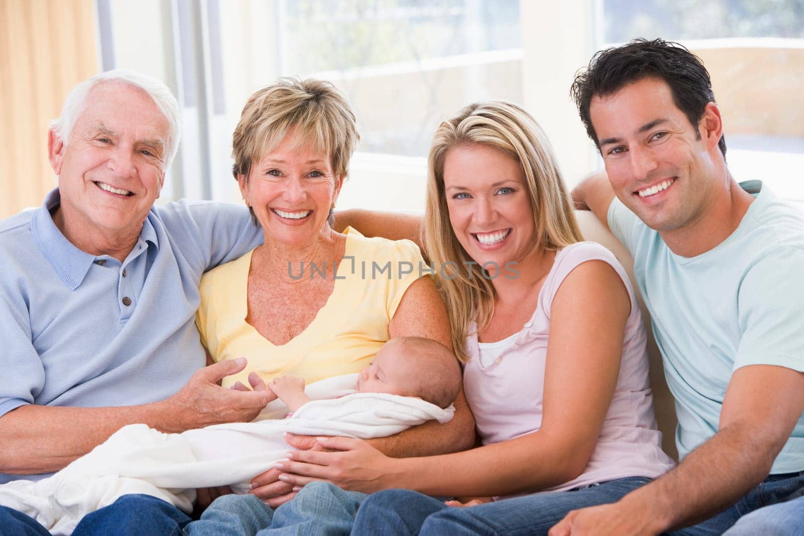 Family in living room with baby smiling