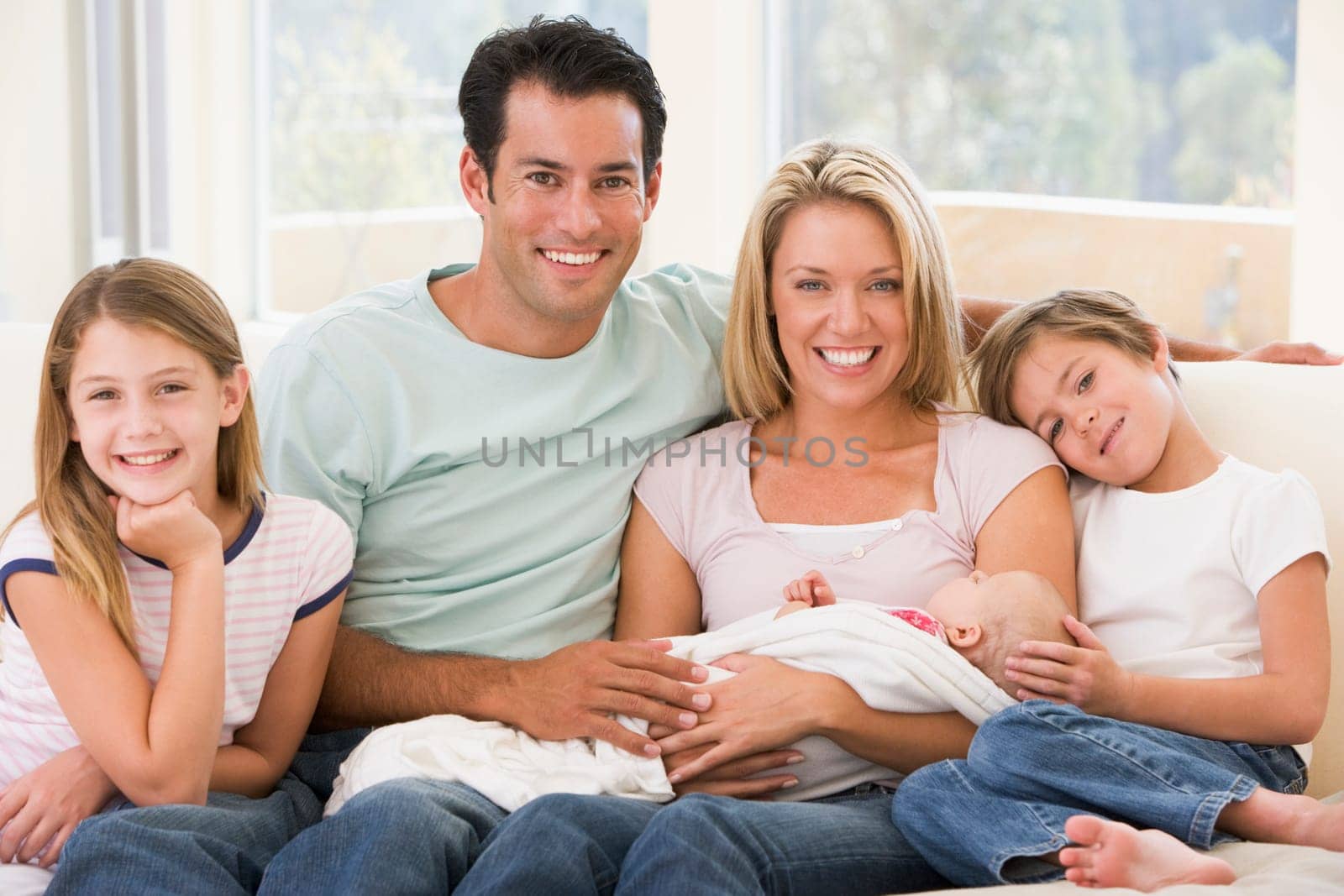 Family in living room with baby smiling