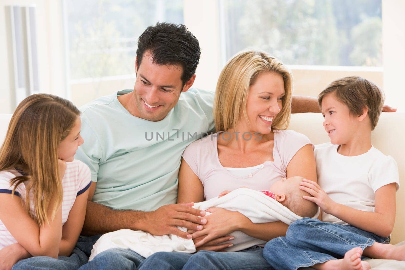 Family in living room with baby smiling