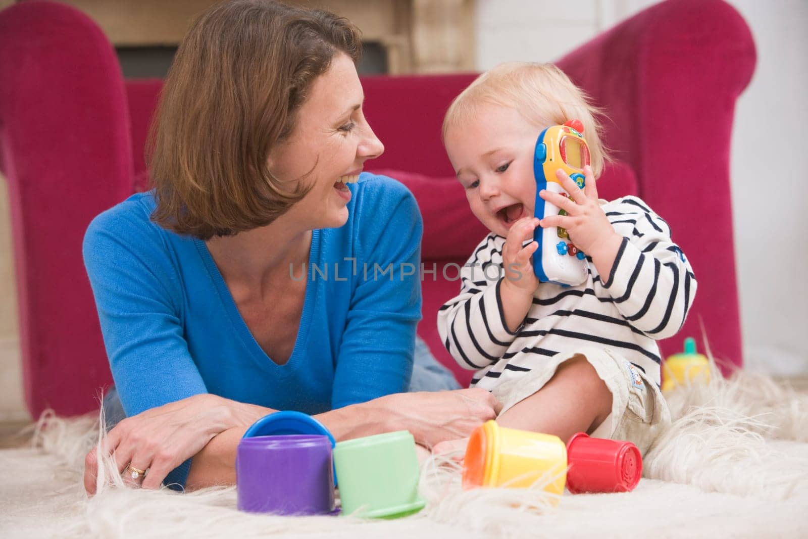 Mother in living room playing with baby smiling