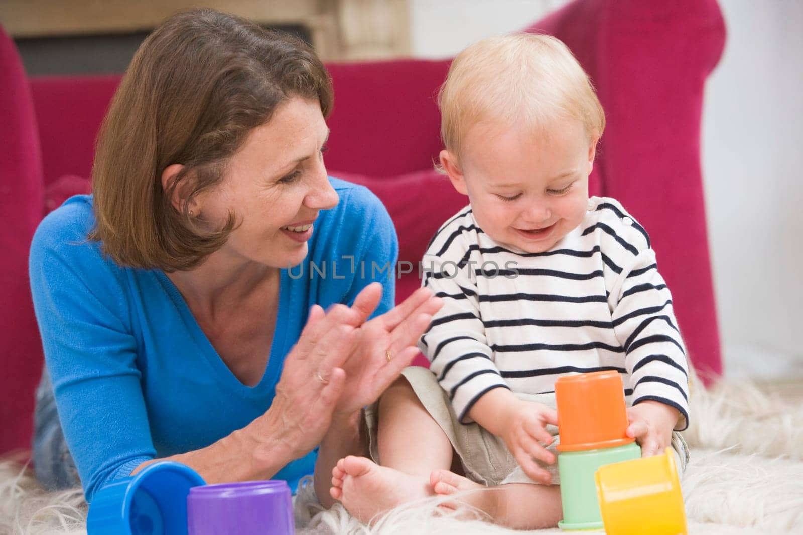 Mother in living room playing with baby smiling