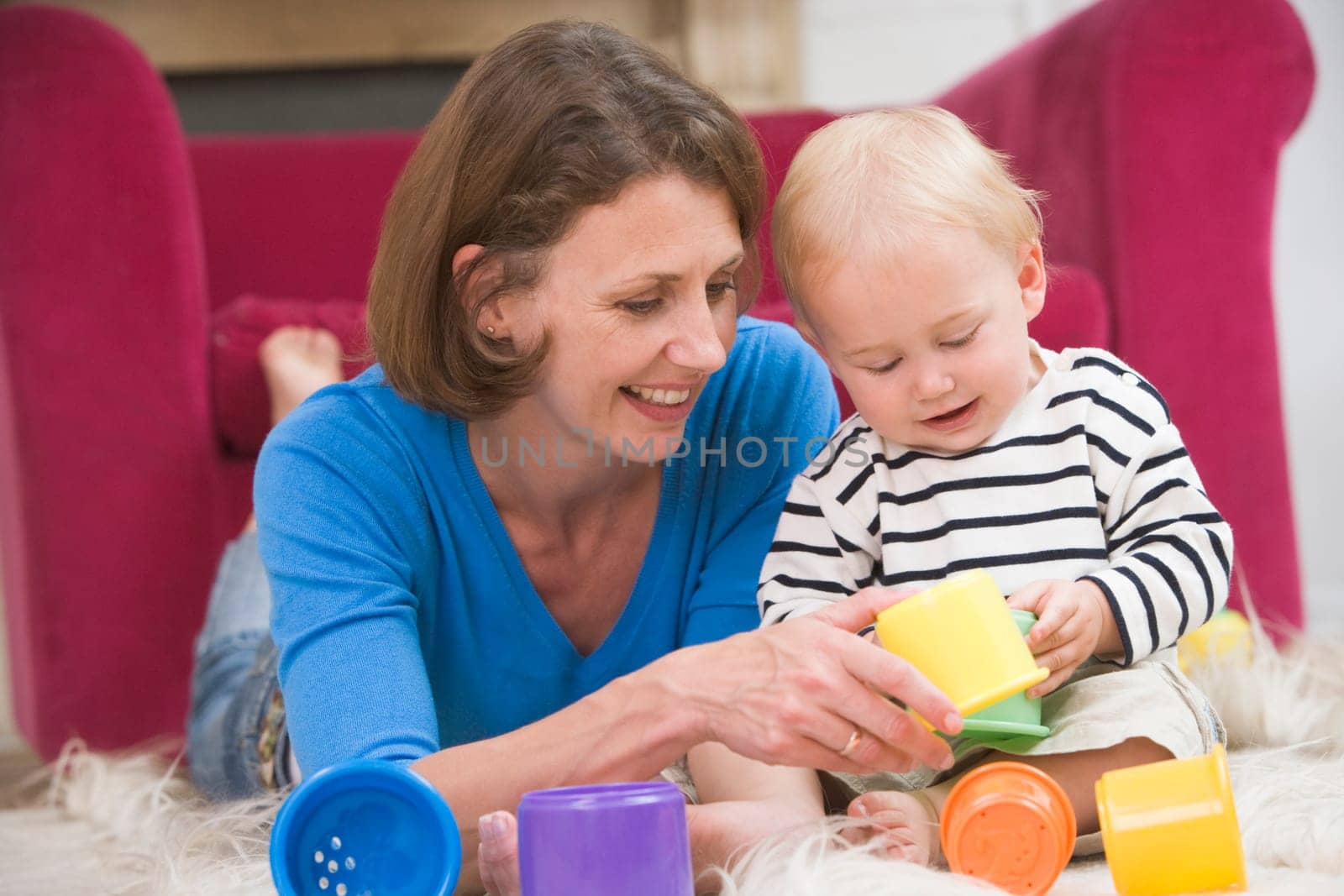 Mother in living room playing with baby smiling