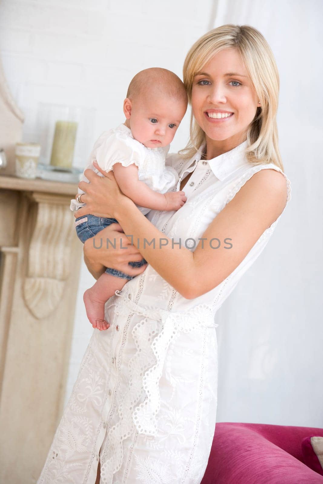 Mother in living room holding baby smiling