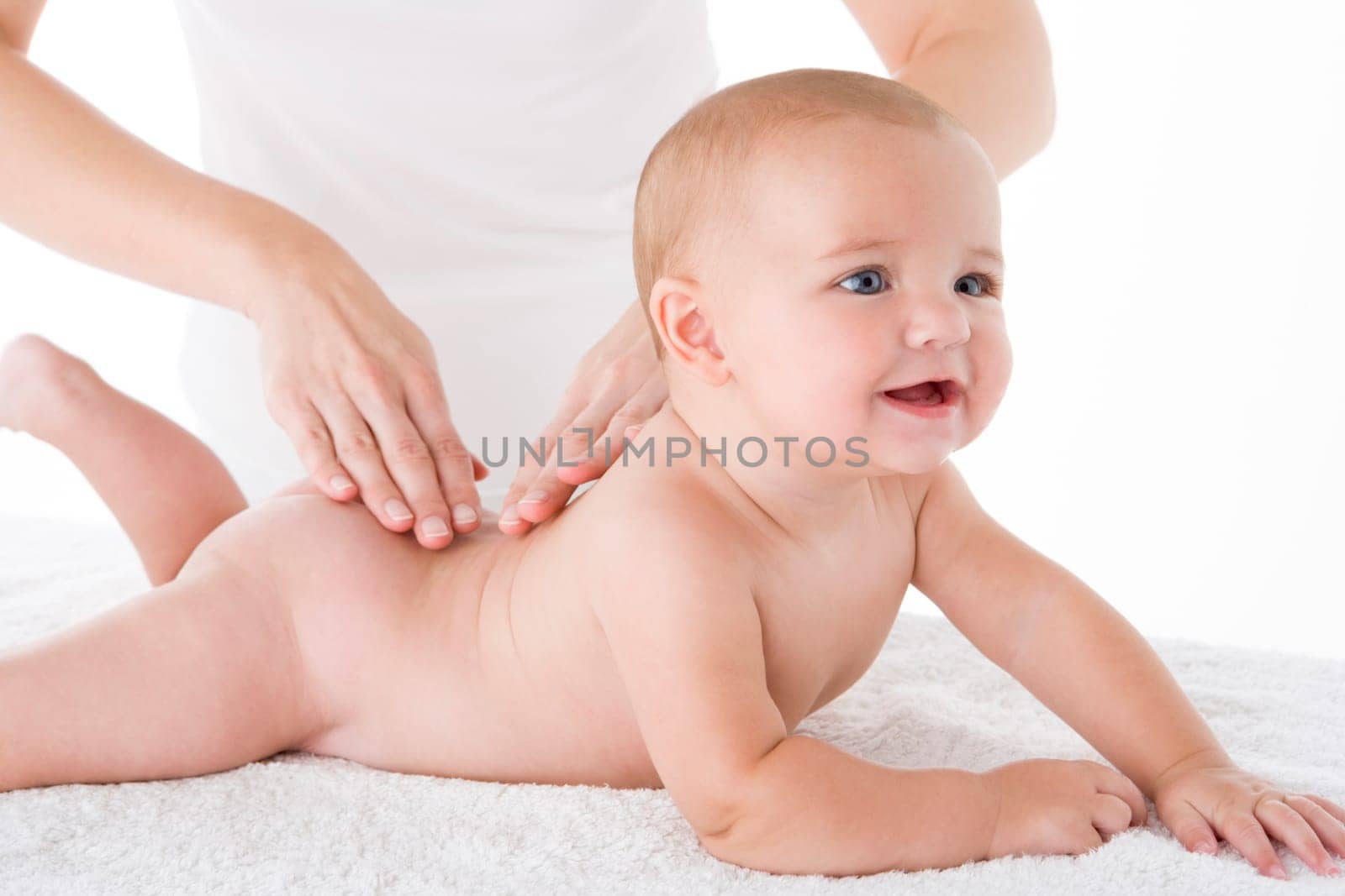 Mother massaging baby