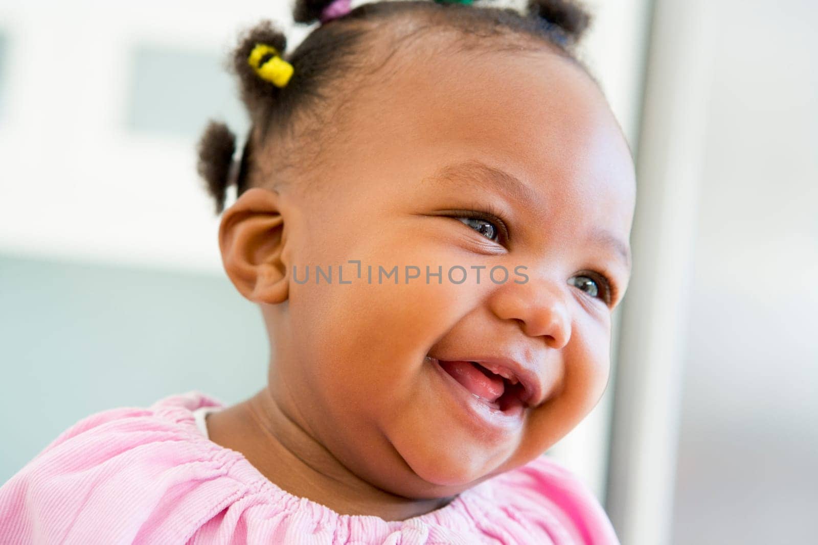 Baby indoors laughing