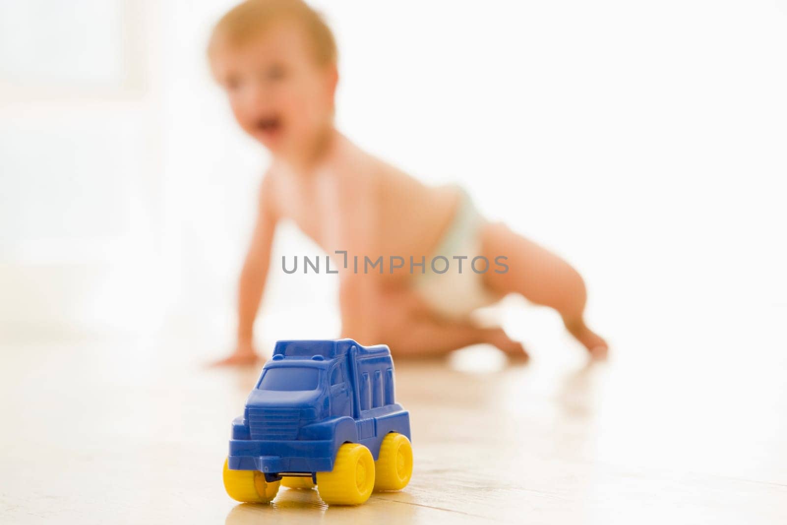 Baby indoors with toy truck