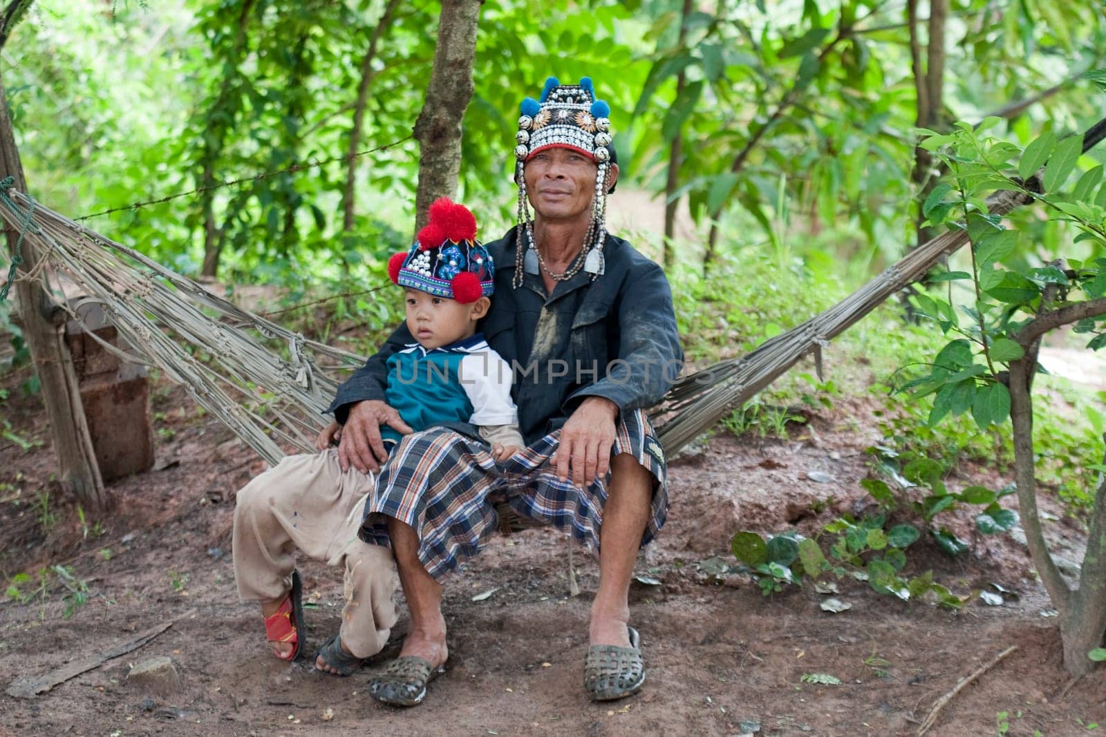 Man with child from Asia on hammock,Akha