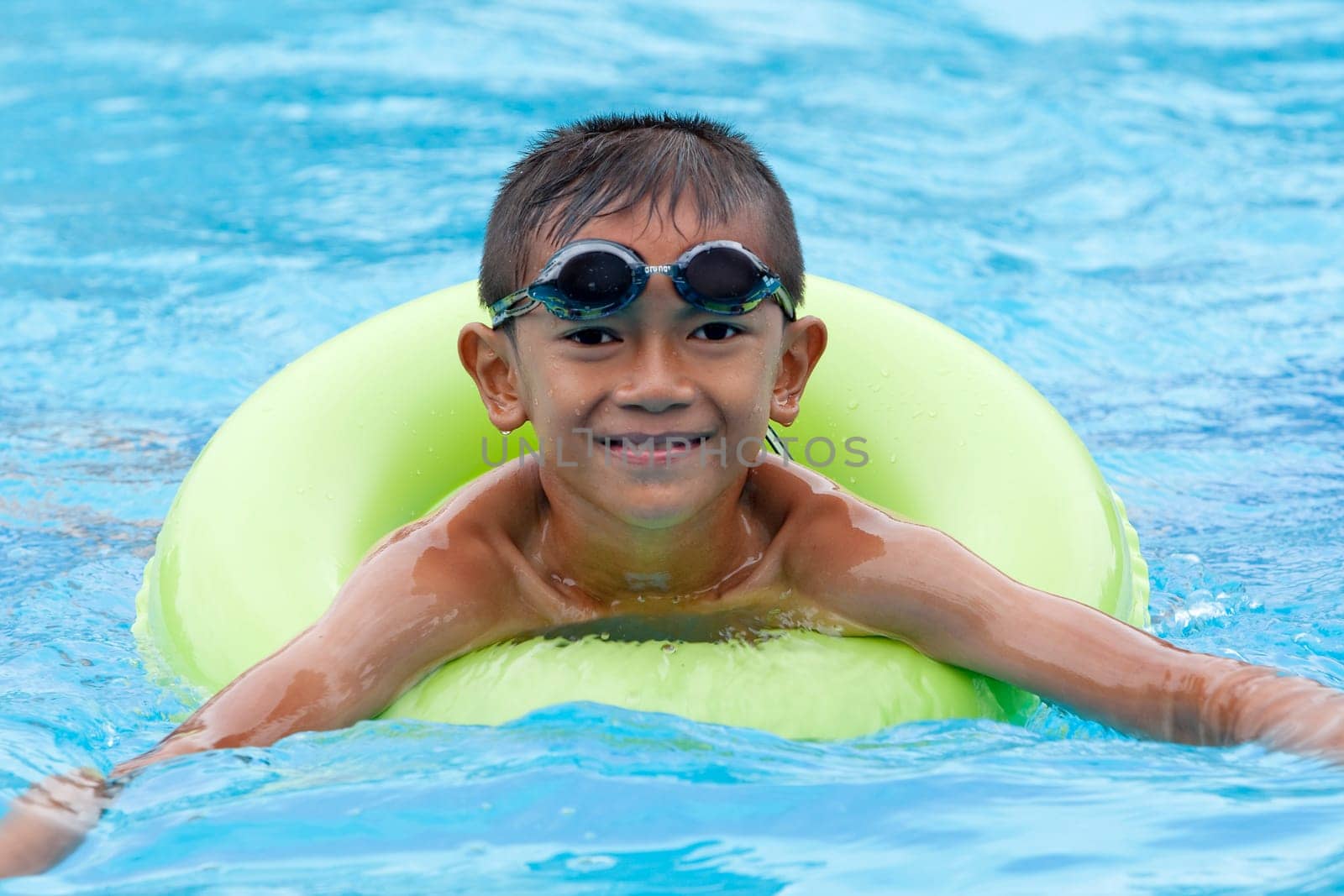 Child with swimming ring in the water
