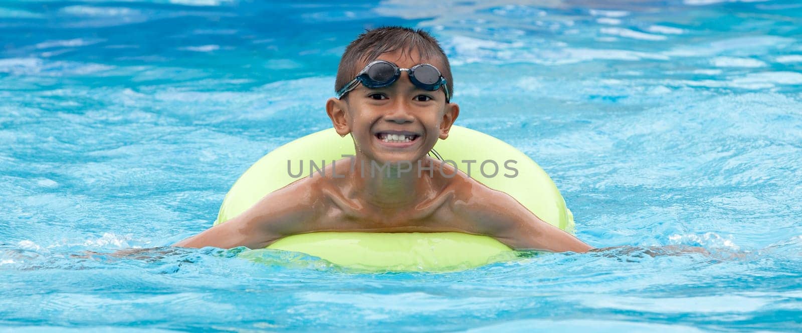 Child with swimming ring in the water