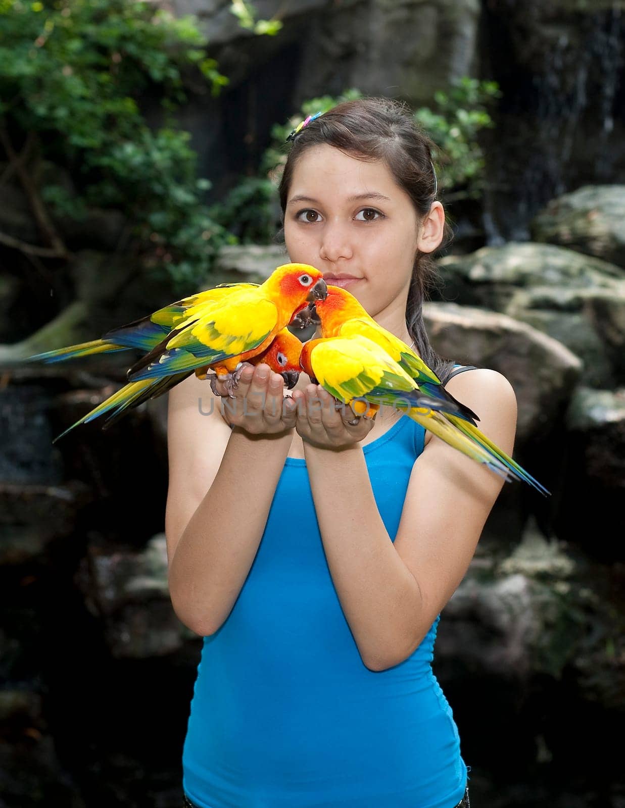 Female teenager with parakeet