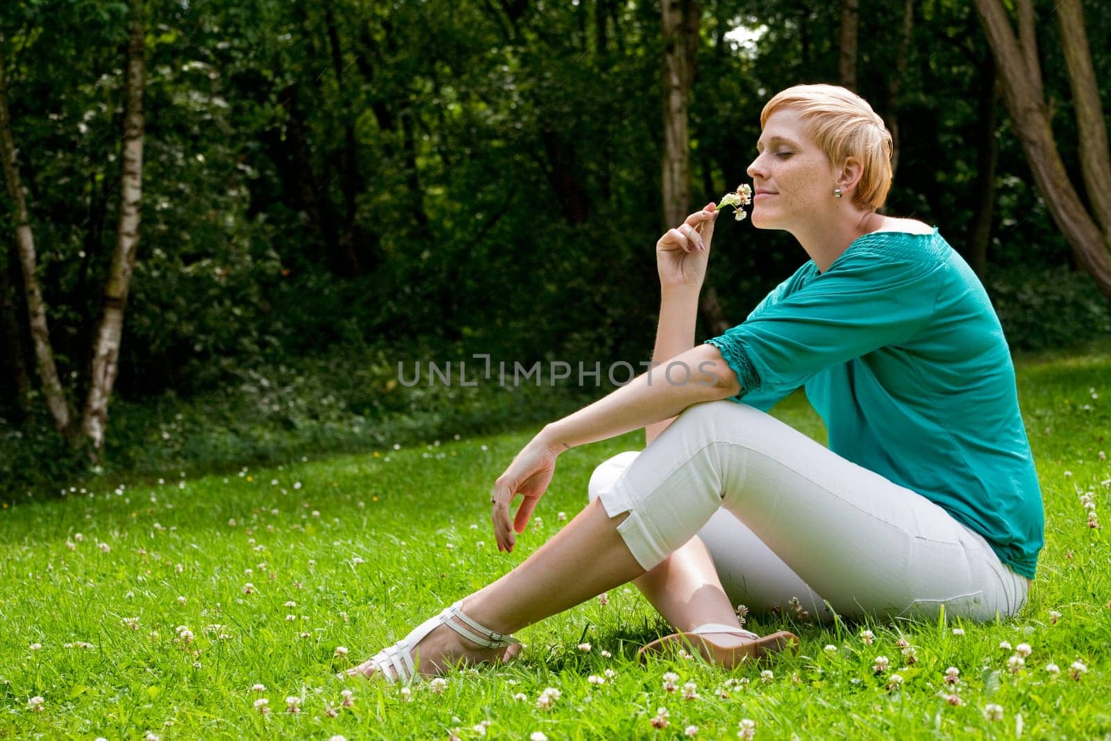 Smelling a flower on the grass