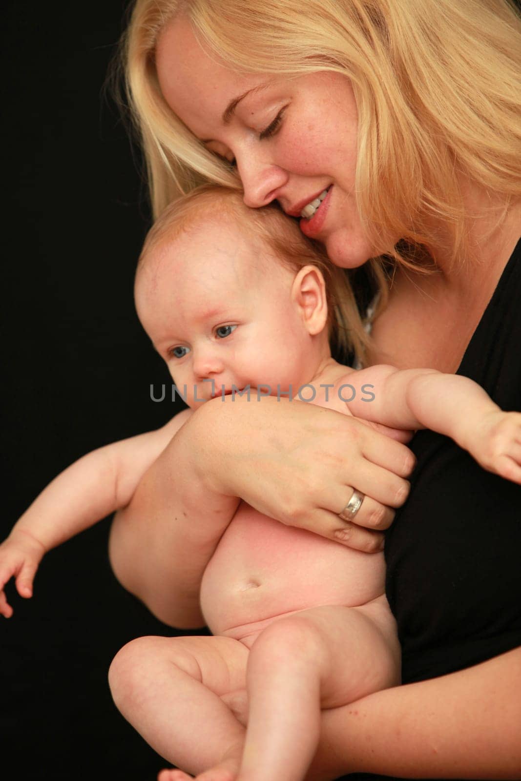 Mother lovingly holds her baby in her arms