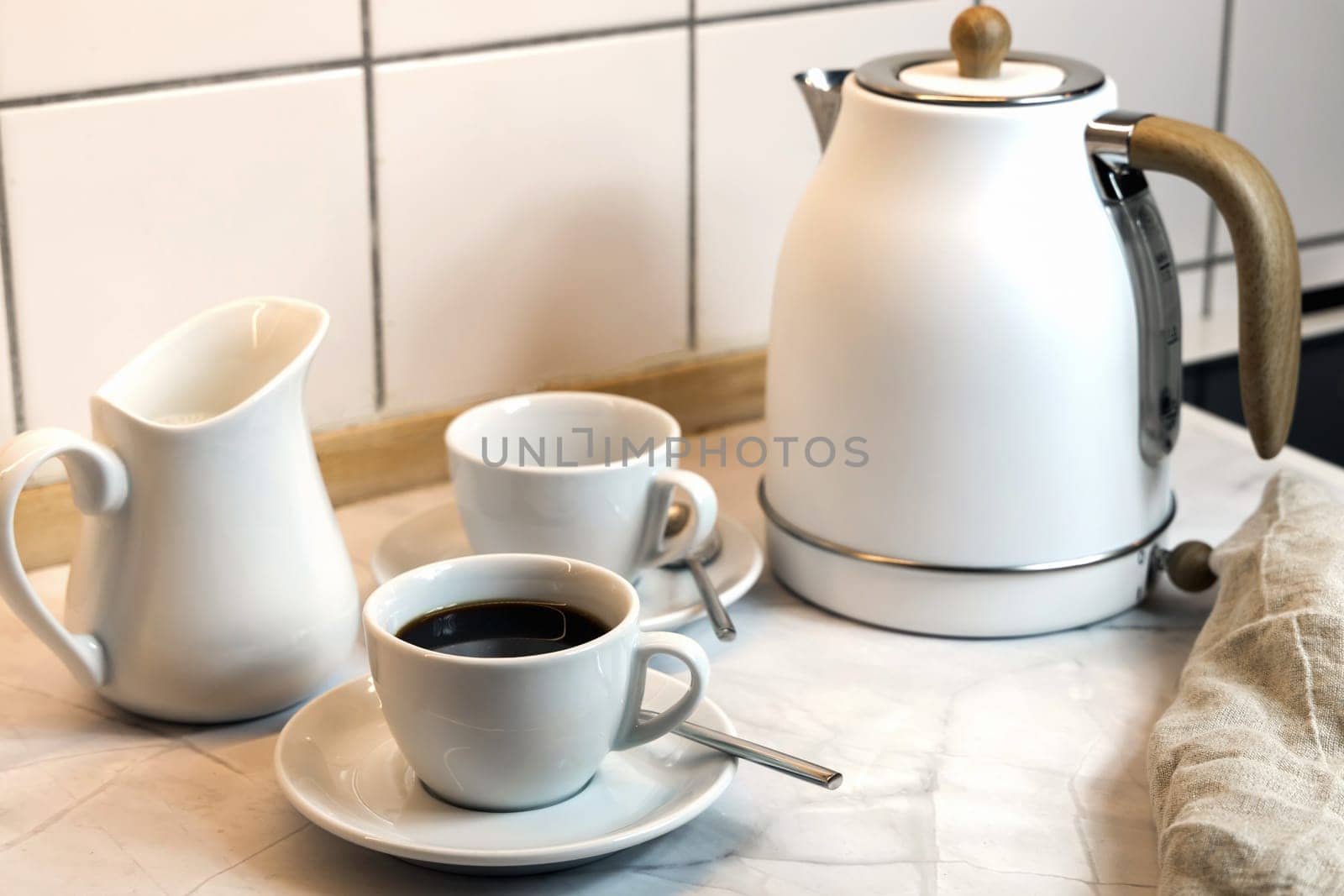 Breakfast on the kitchen table with coffee cup and kettle. High quality photo