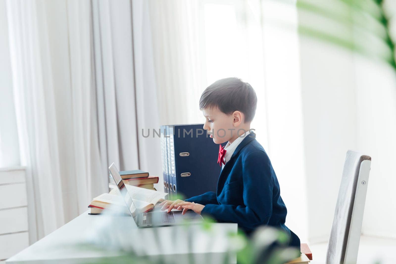 a student works in classroom office in an educational institution behind a laptop in the office