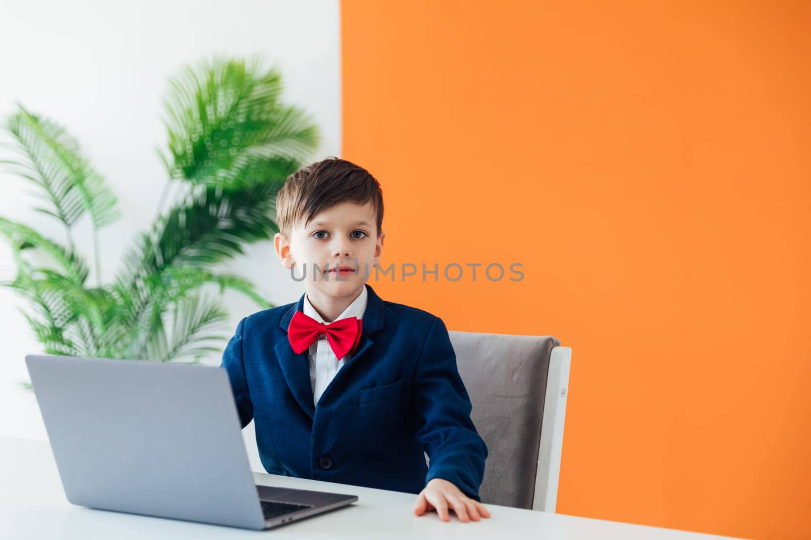 at school in room in the classroom education online boy sitting at a laptop at a table