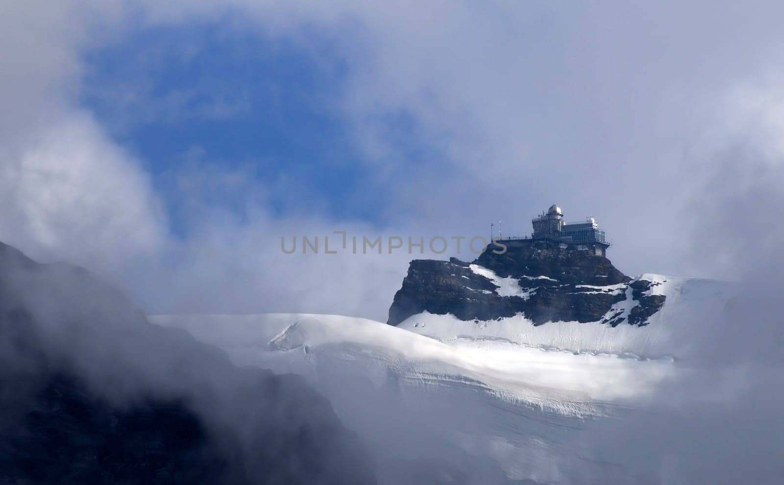 The Jungfraujoch is the highest railway station in Europe. About 600 m to the east rises the "Sphinx"",a striking peak with a height of 3571 m above sea level. It carries an observation deck and a scientific observatory."