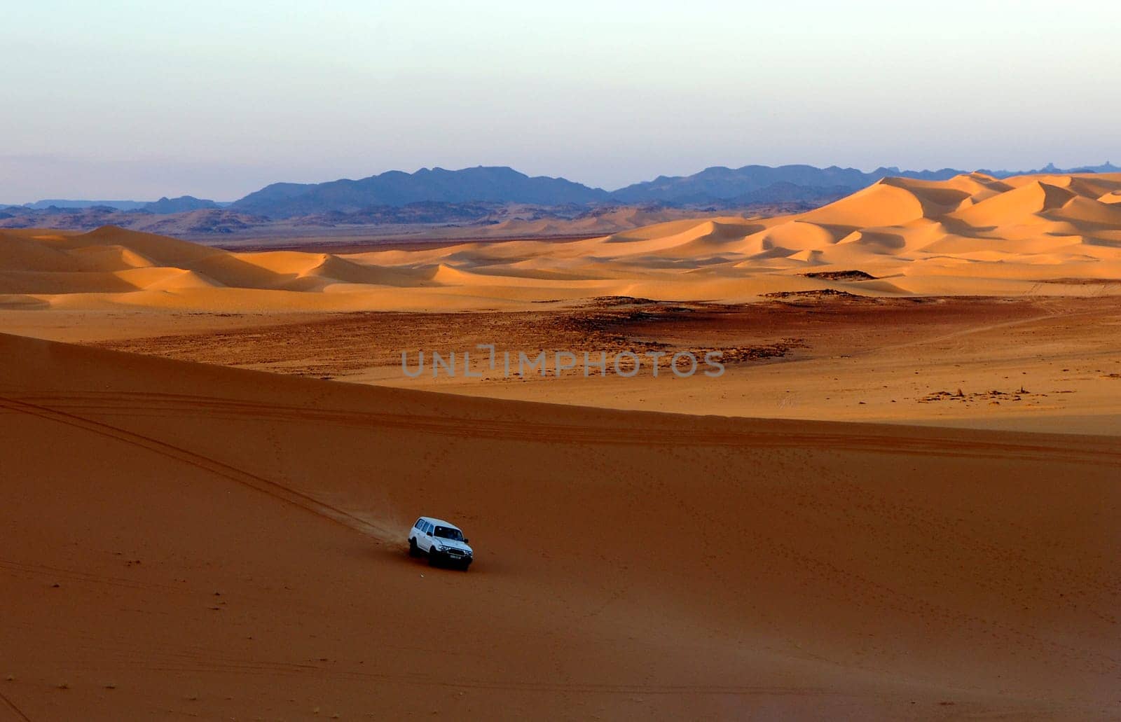 Jeep driving in the sand dunes of the Sahara