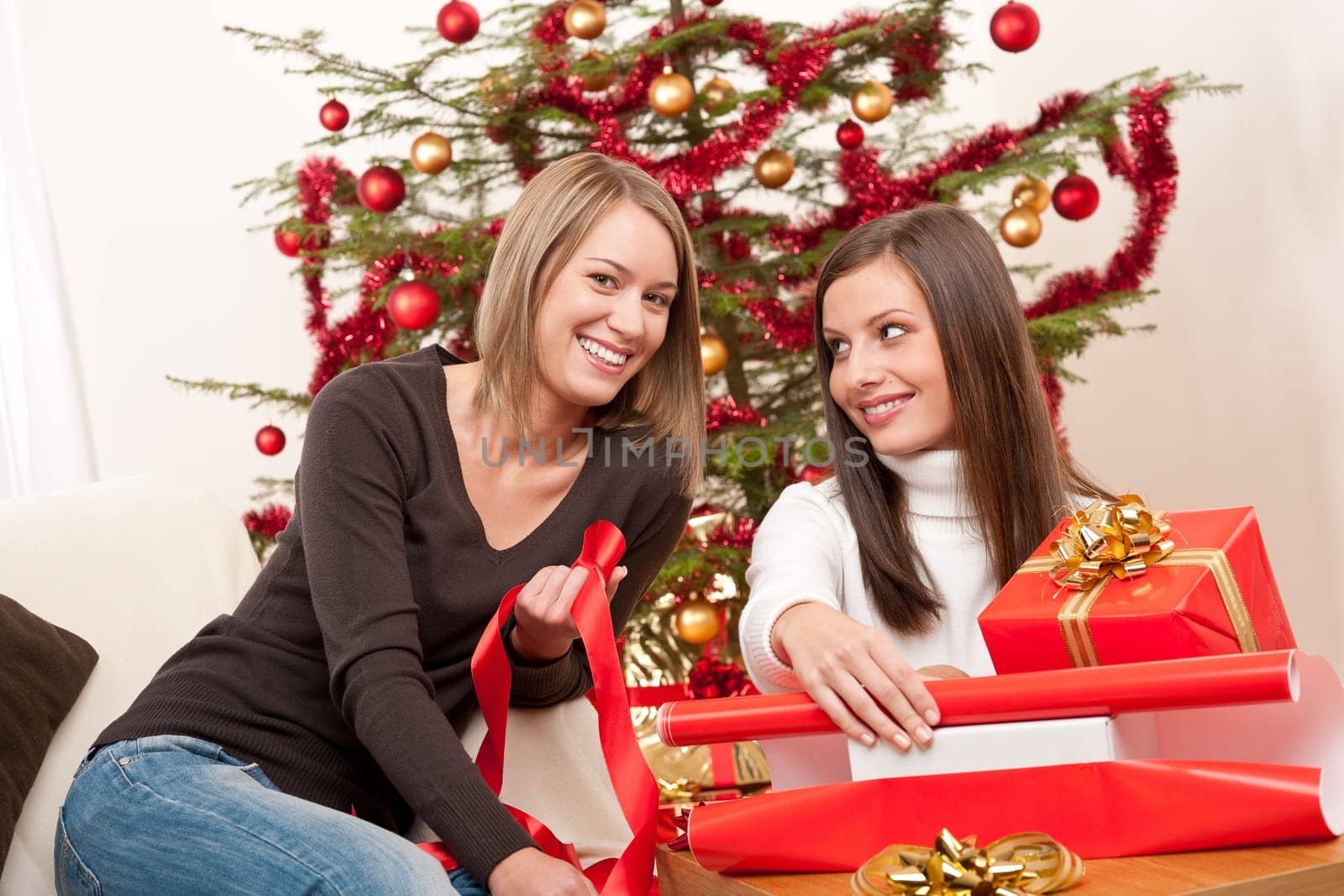 Two women packing Christmas present