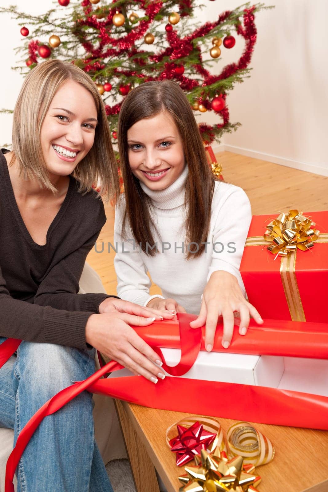 Two women packing Christmas present