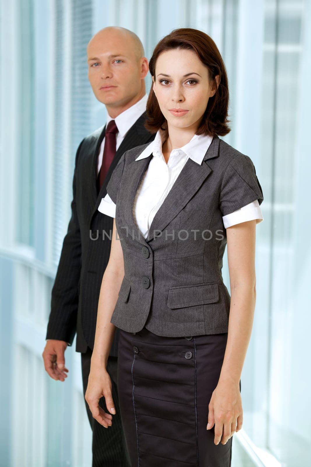 Portrait of young caucasian businessman and businesswoman in office