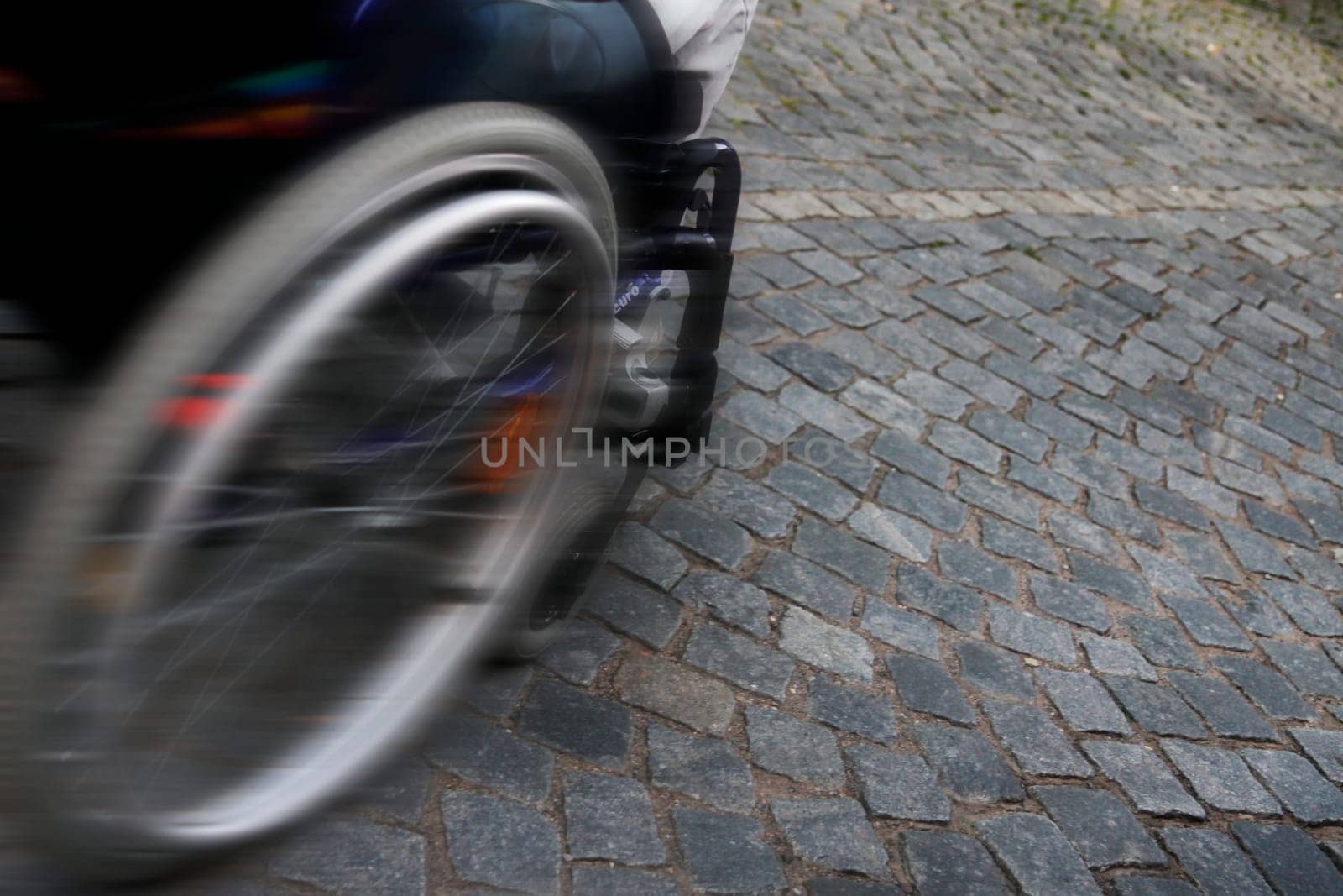 speed - detail wheelchair on cobblestones