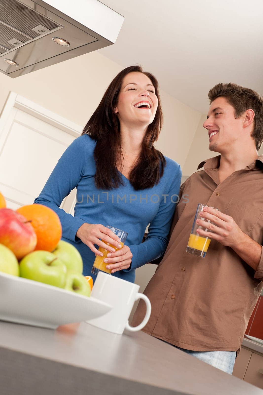 Happy couple drinking orange juice
