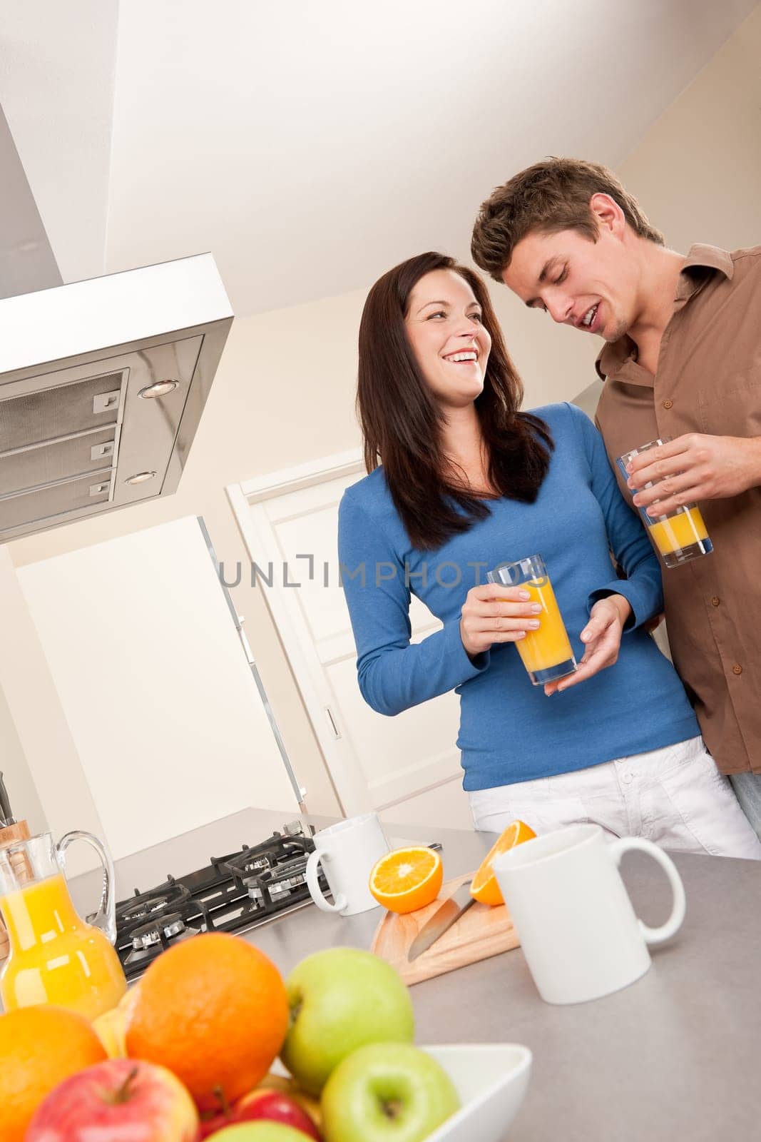 Happy couple drinking orange juice
