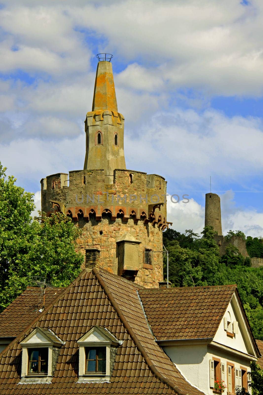 The "Red Tower"",which dates back to the 14th century,served as a prison tower for the city of Weinheim until the middle of the 19th century. (The pyramid cone above the crenellation once had a red tiled roof). Windeck Castle (in the background) was built as a"