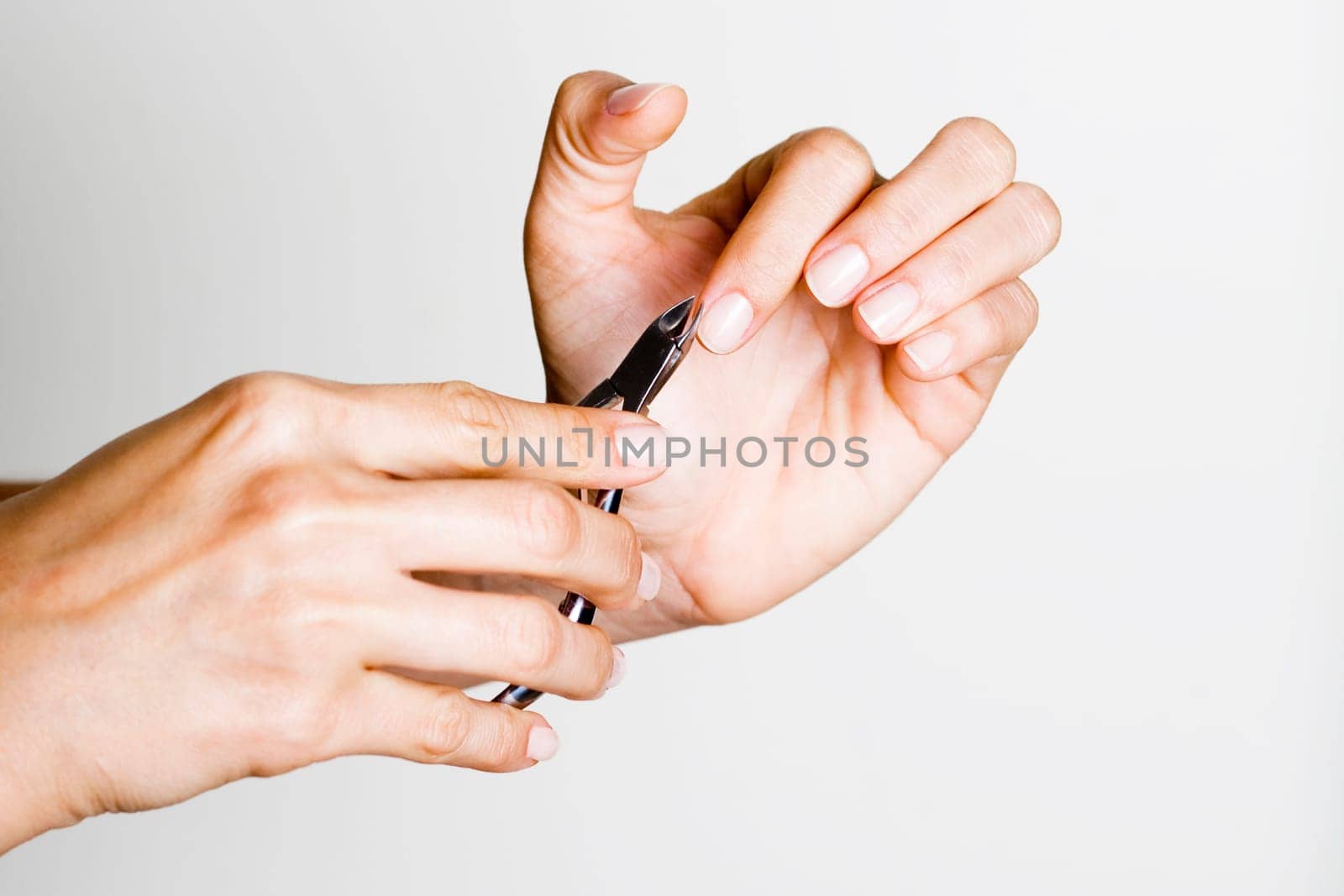 Young woman doing manicure