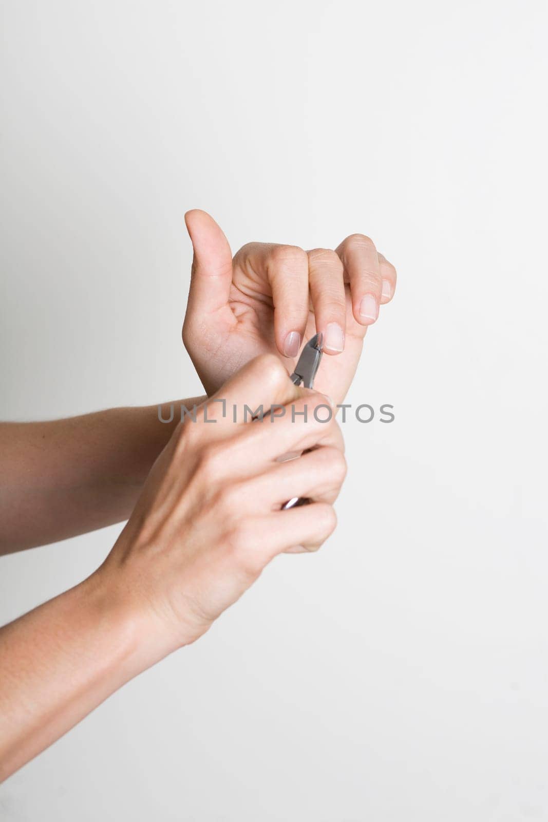 Young woman doing manicure