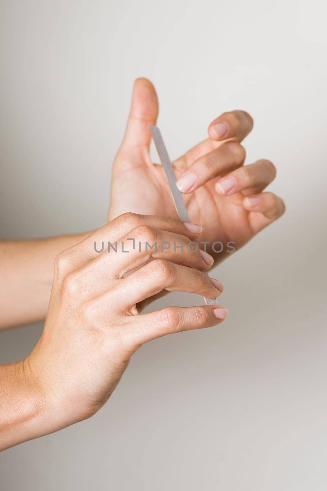 Young woman doing manicure