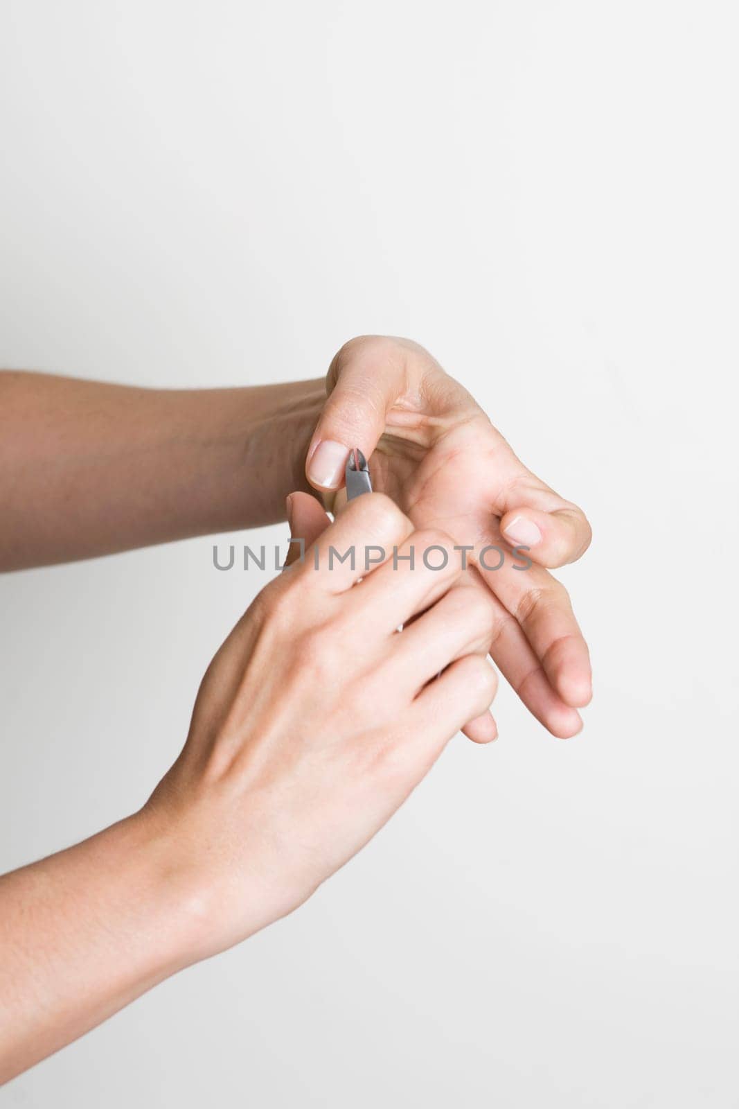 Young woman doing manicure