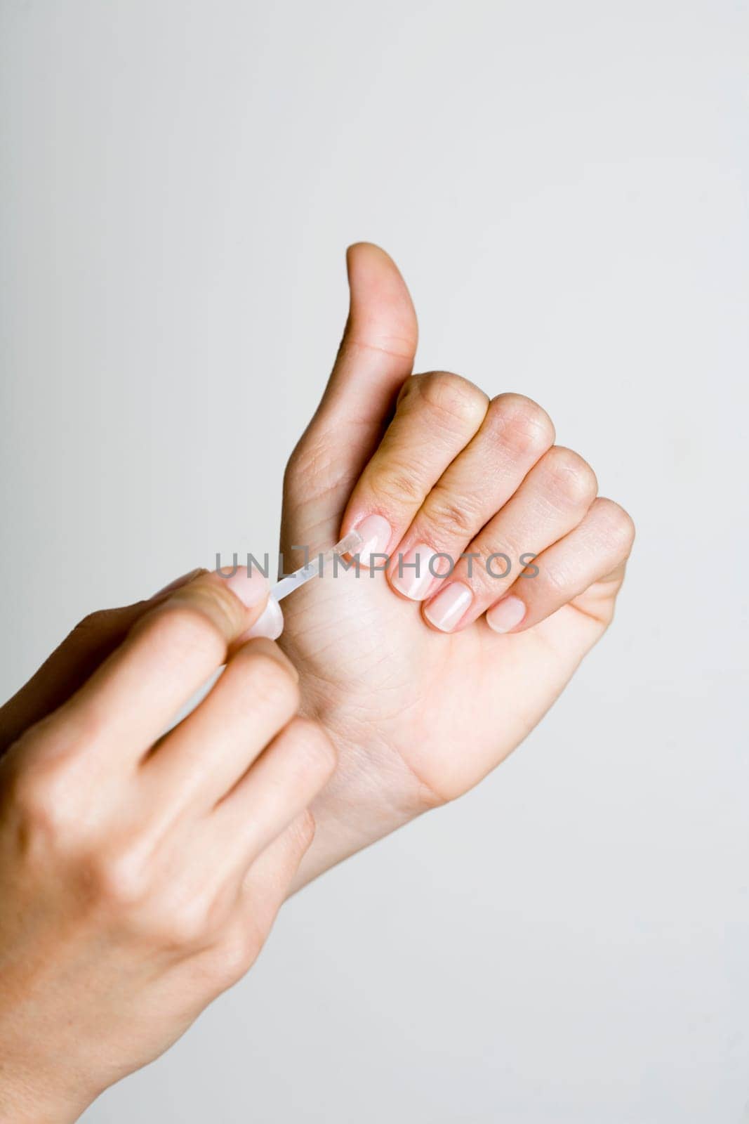 Young woman doing manicure