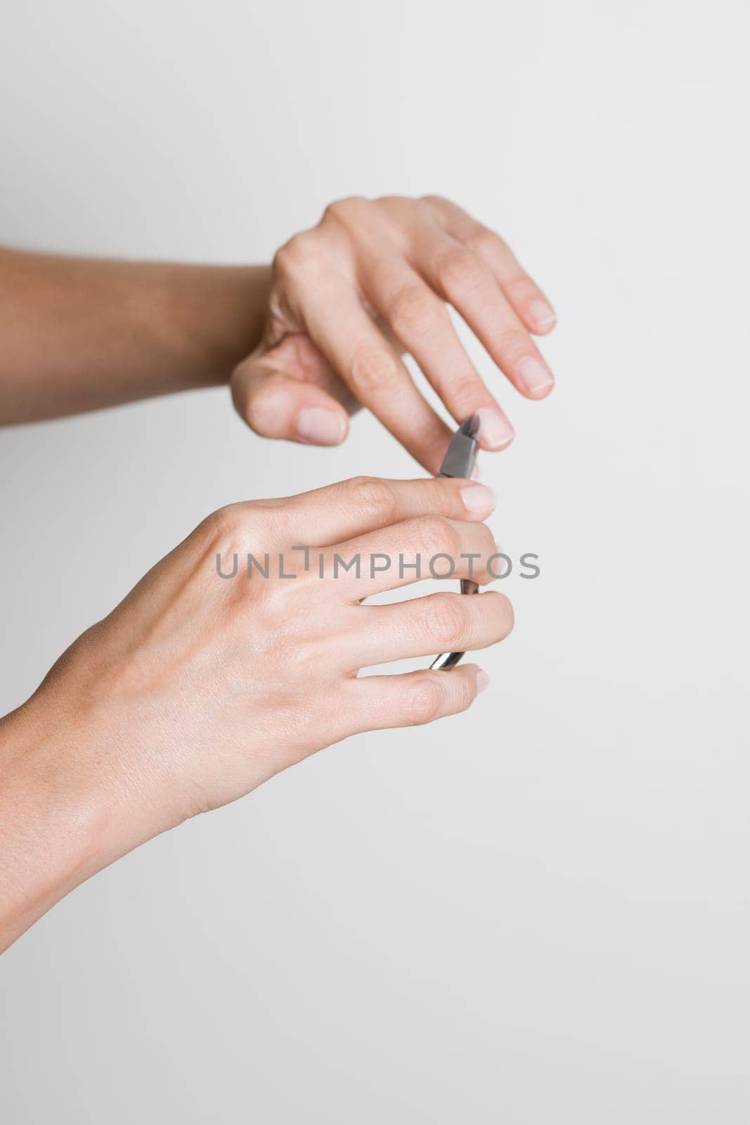 Young woman doing manicure
