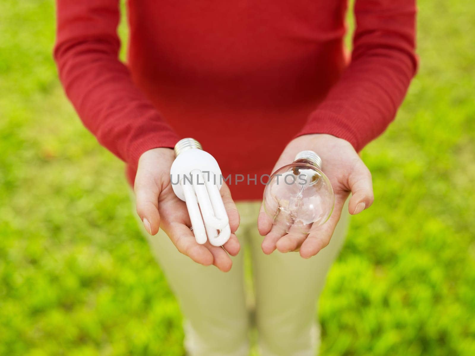 Woman holding light bulbs. Selective focus, high angle view