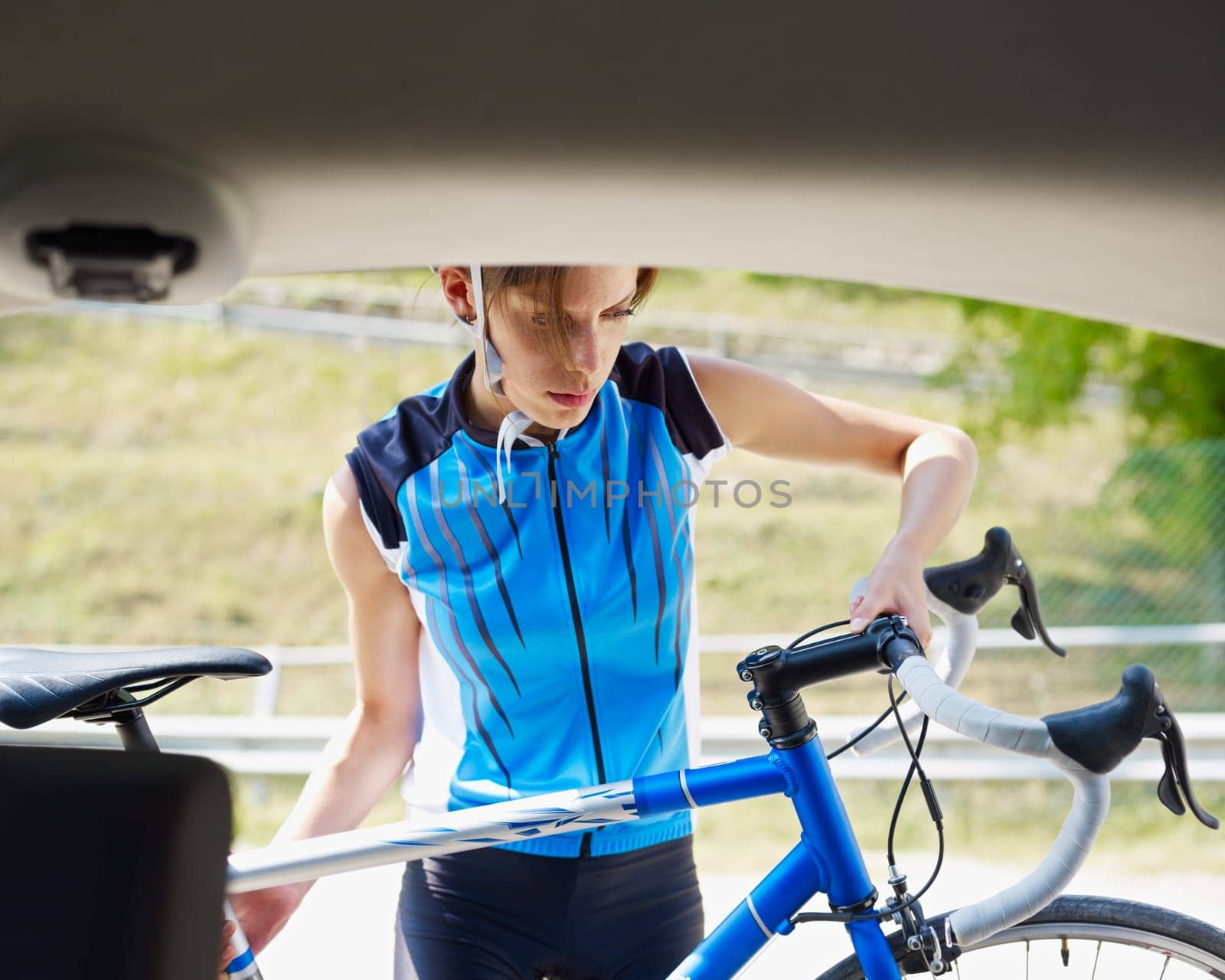 woman unloading blue road bike. Copy space