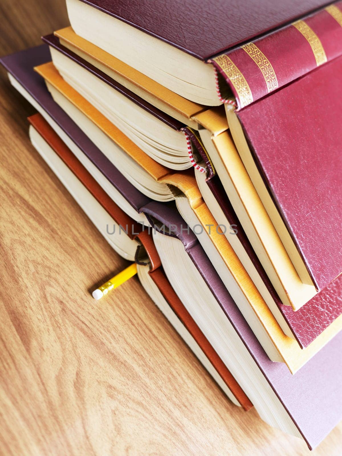 pile of books and pencil on desk. Copy space